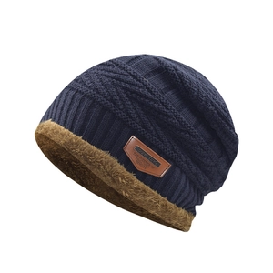 Detail of navy knit beanie showing thick brown faux fur lining and texture