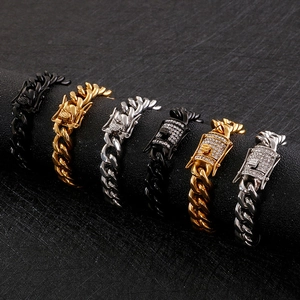 Polished Cuban link bracelets for men in black, gold, and silver styles on a display stand