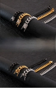 Close-up of polished steel Cuban link bracelets in gold, black, and silver with diamond clasp
