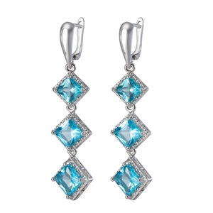Silver drop earrings with three sky blue square zircons on a white background