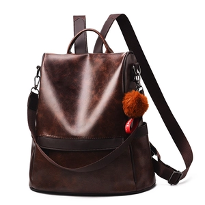 Vintage brown faux leather backpack with large capacity and plush ball charm in soft finish