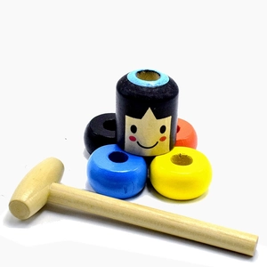 Detail showing colorful wooden block man parts and small mallet on white background