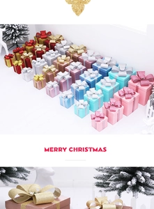 Detailed view of festive glitter Christmas gift boxes in various colors and sizes