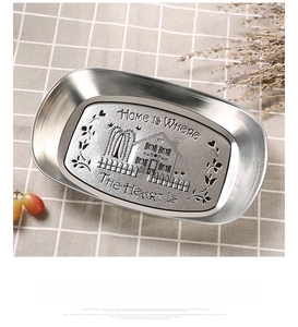 Macro detail of oval tinplate tray with engraved vintage house and home quote design