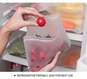 Reusable food-grade EVA storage bag being placed into a refrigerator with tomatoes