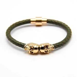 Men's punk green braided leather bracelet featuring golden skull charms and magnetic clasp