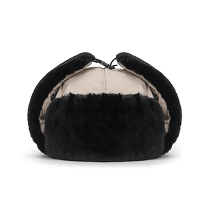 Beige winter trapper hat with black faux fur lining and chin strap buckle for wind protection