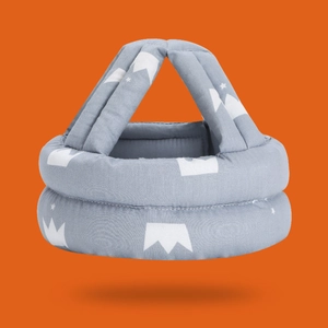 Detail view of baby safety helmet with grey crown pattern and soft padded protection