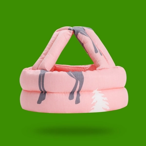 Detail of pink baby safety helmet with elk pattern and soft cotton padding