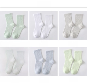 Detail view of solid color crew socks in candy shades with ribbed cotton knit texture