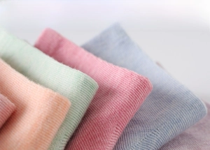 Macro shot of soft knitted cotton fabric texture on colorful high-waist mid-calf socks