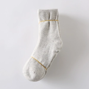 Detail of light gray knitted cotton blend socks with soft texture and minimalist design