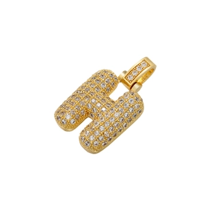 Close-up of golden letter H pendant with iced-out pave set cubic zirconia stones
