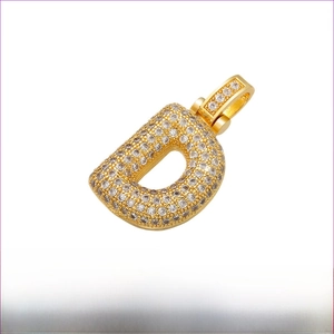 Macro view of gold brass letter D pendant with cubic zirconia inlay and measurements