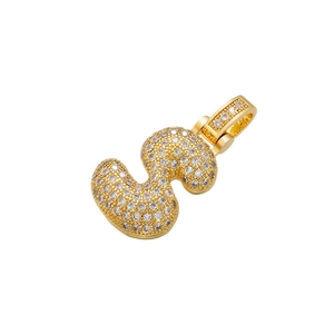 Macro shot of gold-plated letter S pendant with iced out pave setting small crystals