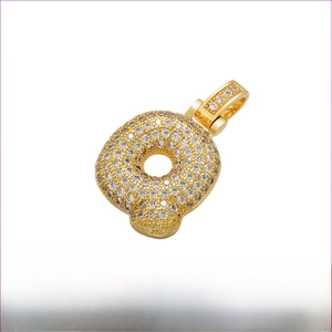 Detailed view of gold plated brass letter Q pendant with iced out cubic zirconia stones