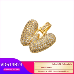 Detailed macro view of a gold-plated brass hip-hop butterfly pendant with CZ stones