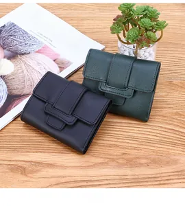 Detail view of tri-fold short wallets with lychee texture in dark green and navy blue