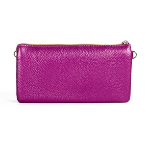 Detail of purple litchi grain leather texture with gold zipper and metal hooks