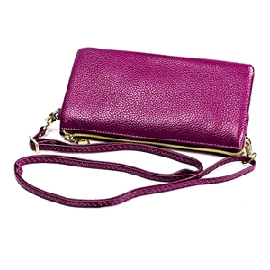 Detail of lychee pattern leather crossbody bag in deep purple with gold zipper