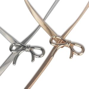 Detail of elegant gold and silver bow elastic waist belts for dresses and sweaters