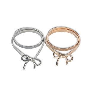 Elegant bow-knot elastic metal waist chains in gold and silver colors on white background