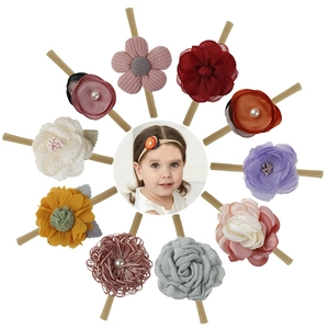 Close-up of 10-piece baby floral headbands with fabric roses and pearl details