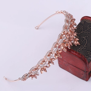 Detailed view of rose gold bridal tiara with amber crystals and leaf design accents