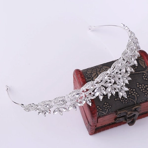 Close-up of silver crystal bridal crown with leaf design on a vintage jewelry box