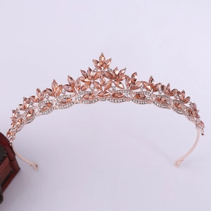 Close-up of rose gold bridal crown with champagne crystals and leaf vine details