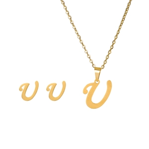 Detail shot of golden letter V pendant necklace and matching stud earrings set