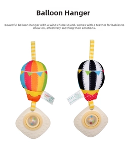 Detail of baby stroller hanging toys featuring hot air balloon rattles and teething rings