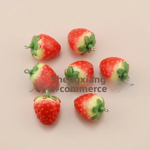 Detail view of seven miniature red resin strawberries with green leaves for DIY crafts