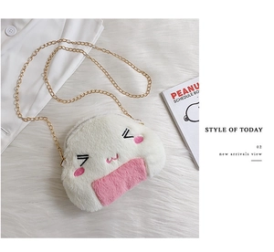 Close-up of cute rice ball plush bag with detailed embroidery and golden metal chain