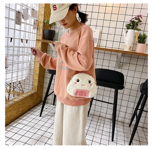 Plush rice ball shoulder bag with cute embroidery and metal chain shown on a model