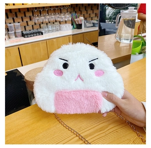 Close-up of white plush rice ball bag with angry expression embroidery and gold chain