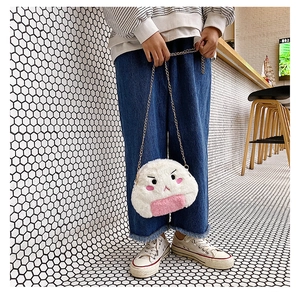 Detail of cute rice ball plush bag with angry face embroidery and metal chain strap