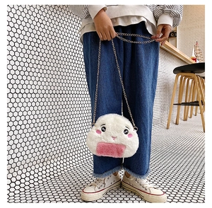 Detail of cute rice ball plush crossbody bag with embroidered face and chain strap