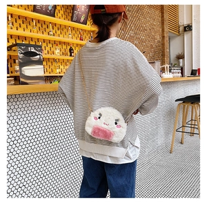 Japanese style plush rice ball crossbody bag with cute embroidery shown on model