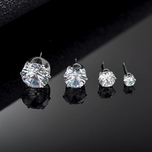 Classic round six-claw cubic zirconia stud earrings in four sizes on reflective black base