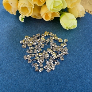 Bulk silver butterfly earring backs scattered on dark blue texture with yellow flowers