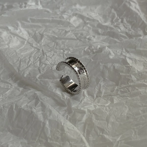 Detail view of adjustable 925 silver ring featuring engraved Smile text and emoji