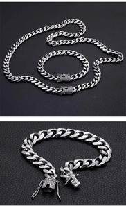 Detail of silver Cuban link necklace and bracelet set with iced-out diamond box clasp