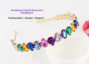 Detail of a gold metal headband featuring teardrop-shaped colorful rhinestones