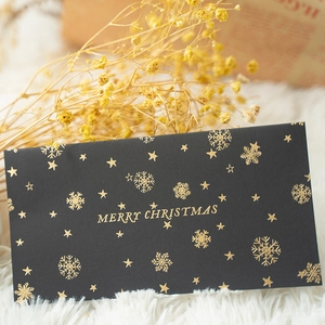 Elegant black gold-stamped Merry Christmas envelope with snowflake and star patterns