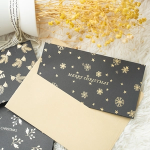 Elegant black Christmas cards with gold foil snowflakes and matching cream envelopes