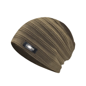 Detailed close-up of dark khaki ribbed knit beanie with a black leather logo patch