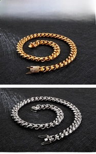 Detail of silver and gold Cuban link chains featuring stone-set lobster dragon clasps