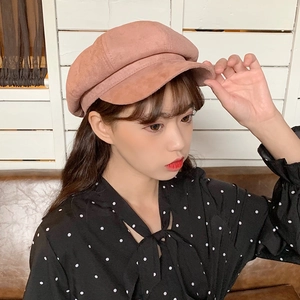 Detail of pink faux suede newsboy cap featuring a classic octagonal paneled crown
