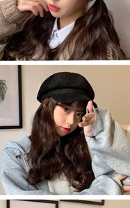 Detail of a black faux suede baker boy hat paired with a grey zip-up hoodie